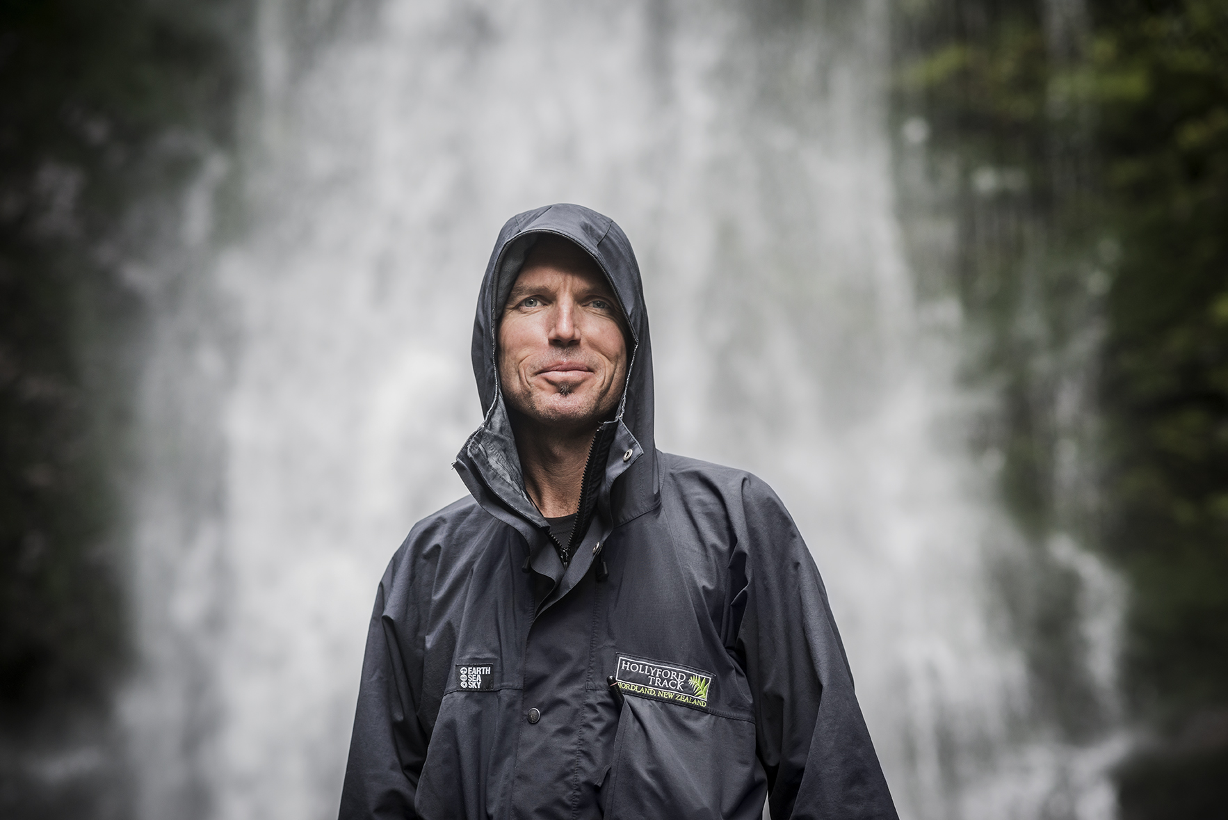 Man standing infront of waterfall